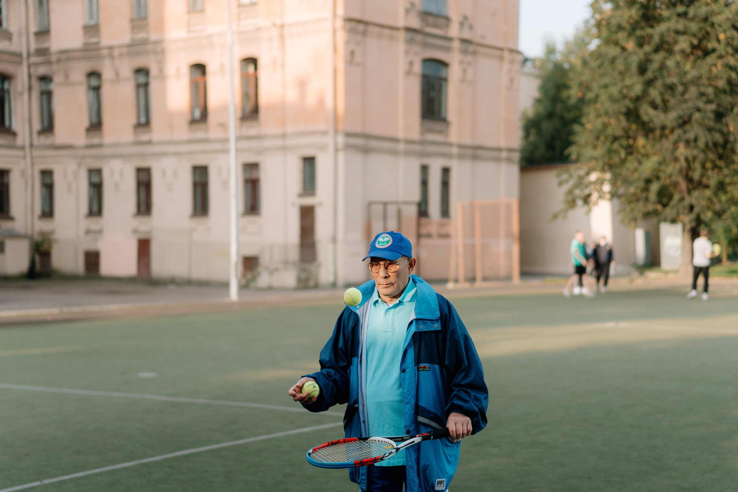 old man playing tennis