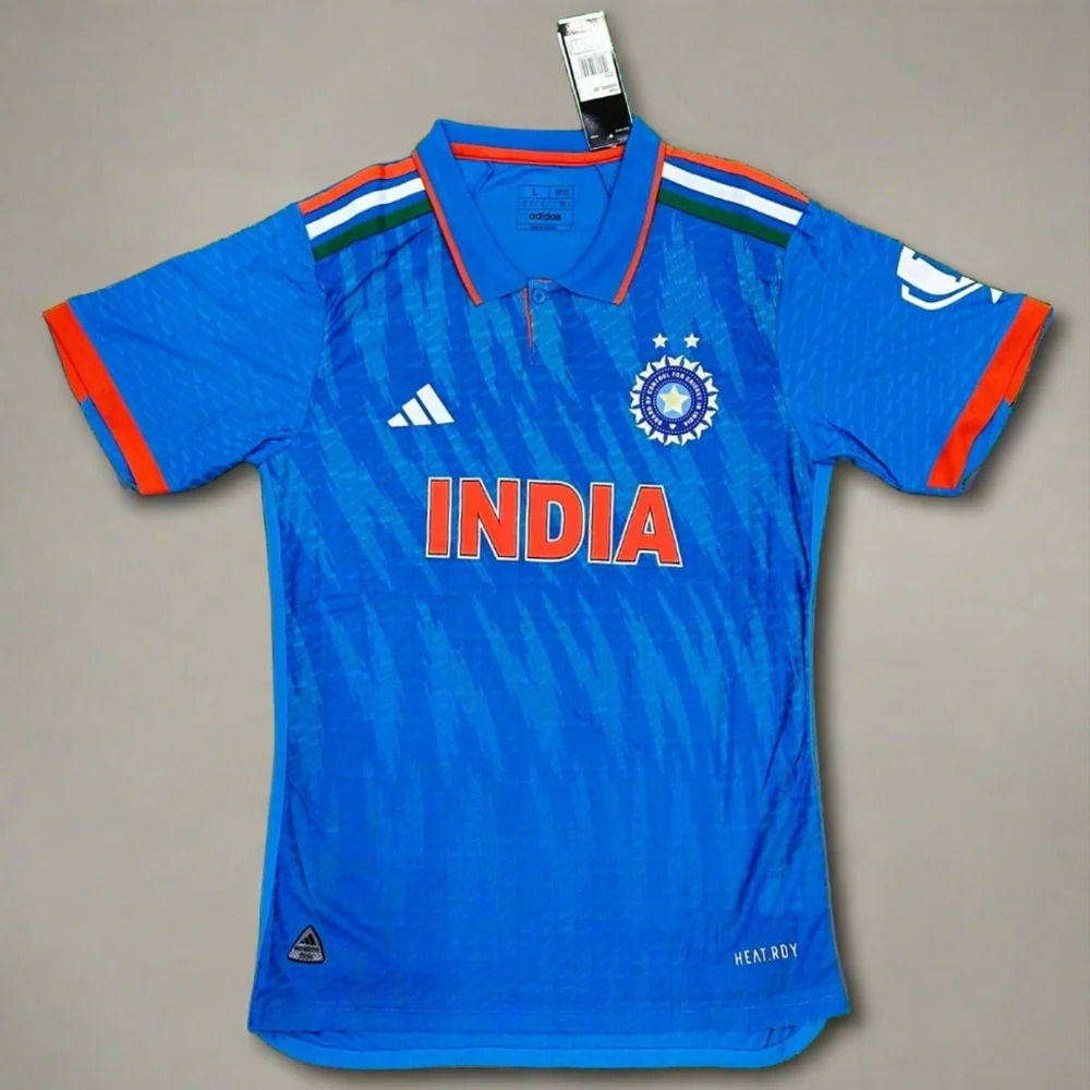 Blue India cricket team jersey with orange accents, Adidas logo, and “INDIA” printed on the front.