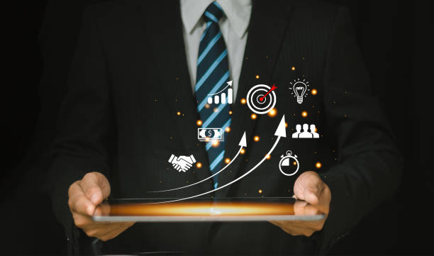 Digital business growth concept showing a businessman with a tablet displaying strategy, target, and marketing icons.