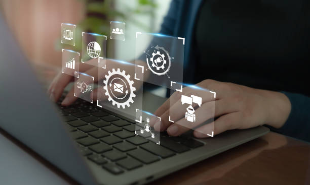 Business user managing digital marketing tools on a laptop with icons for automation, CRM, and communication.