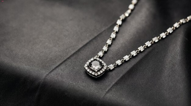 Square diamond necklace with a halo setting on a delicate chain against a dark background.